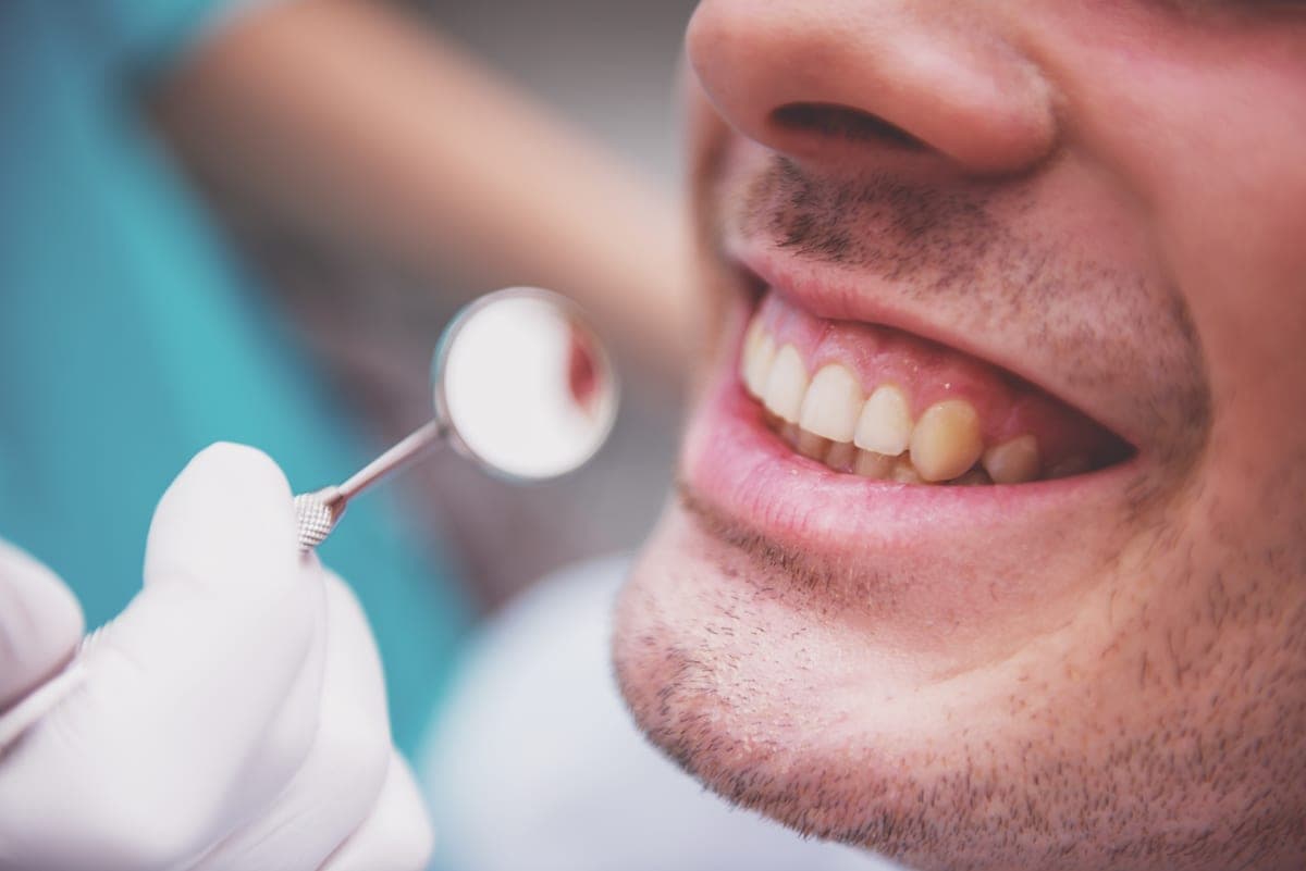Dentist checking gum health before periodontal disease treatment in Clearwater